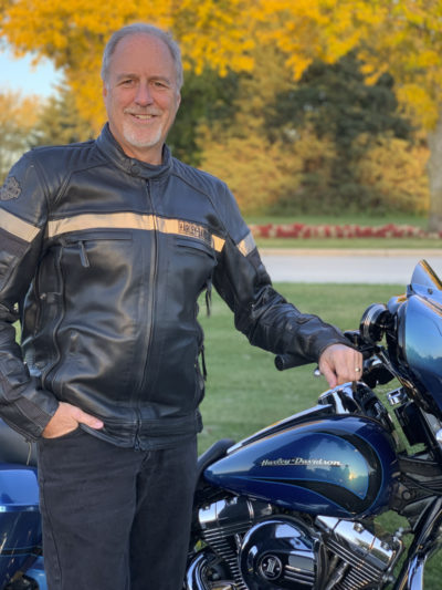 Scott Habegger standing by Harley-Davidson motorcycle